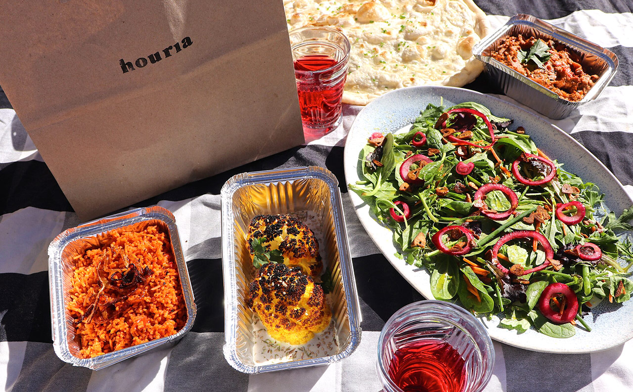 IF Trust partner charity Houria CIC is a Bristol-based anti-slavery and anti-racism organisation, training and hiring female survivors of slavery in a Pan-African catering company. Imag shows food dishes laid out on a cloth