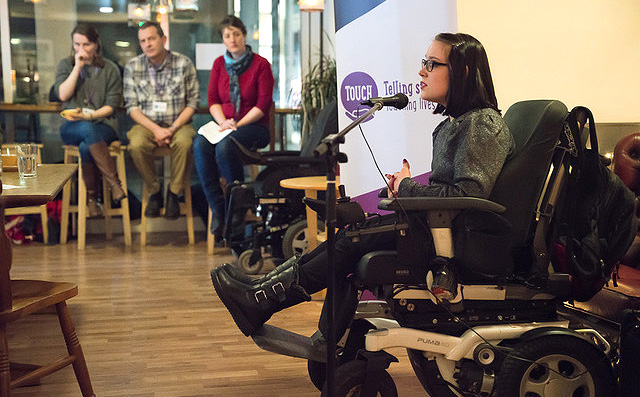 Young woman speaking at microphone Touch Network If Trust